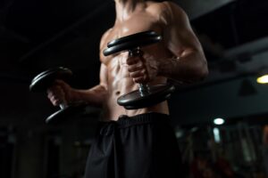 close-up-of-man-with-dumbbells-exercising-in-gym-PNGBLV9-min.jpg